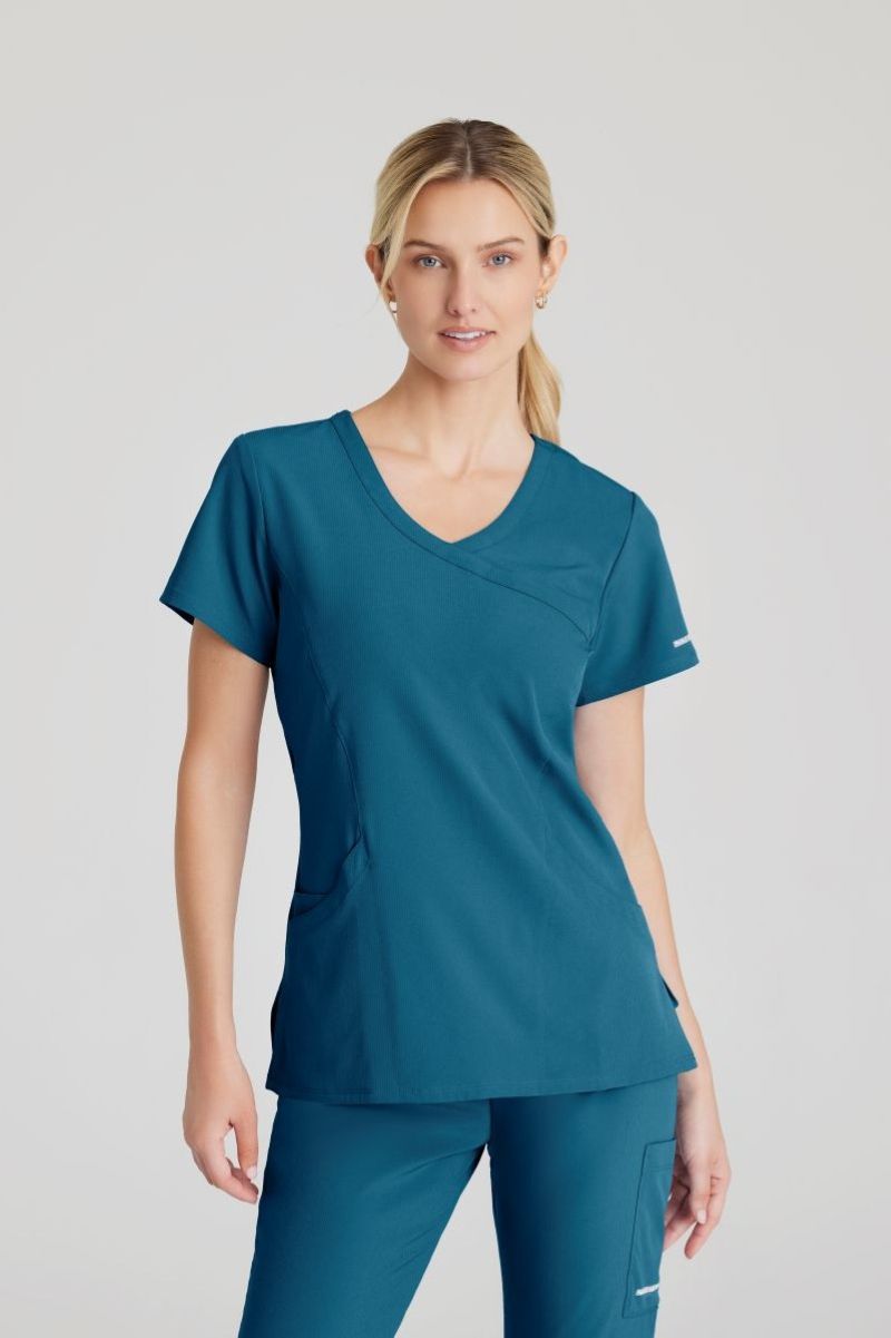 SKECHERS FEMALE RELIANCE 3-POCKET WRAP EFFECT TOP | Bahama / Caribbean