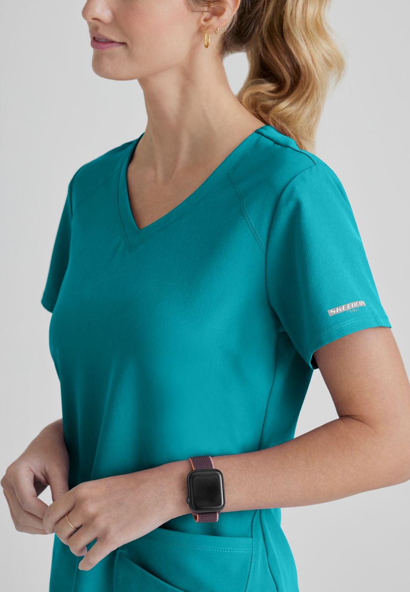 SKECHERS BREEZE 3-POCKET SHAPED HEM TOP | Teal