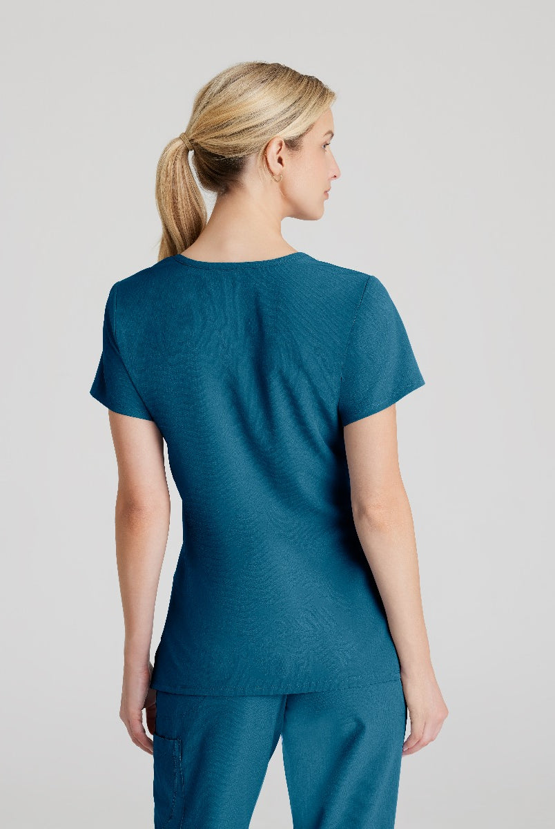 SKECHERS FEMALE RELIANCE 3-POCKET WRAP EFFECT TOP | Bahama / Caribbean