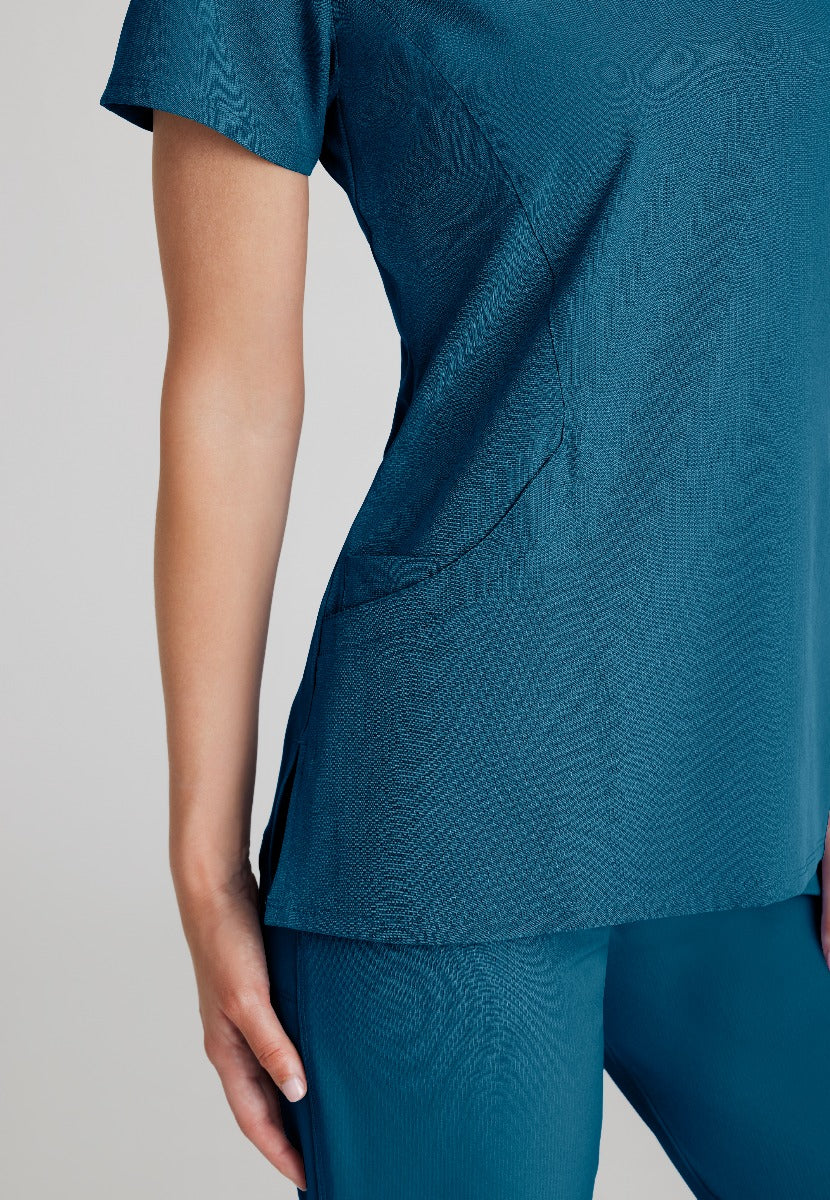 SKECHERS FEMALE RELIANCE 3-POCKET WRAP EFFECT TOP | Bahama / Caribbean