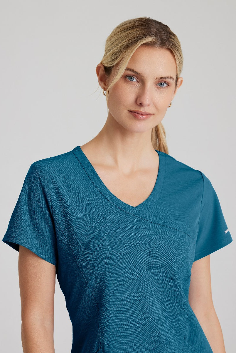 SKECHERS FEMALE RELIANCE 3-POCKET WRAP EFFECT TOP | Bahama / Caribbean
