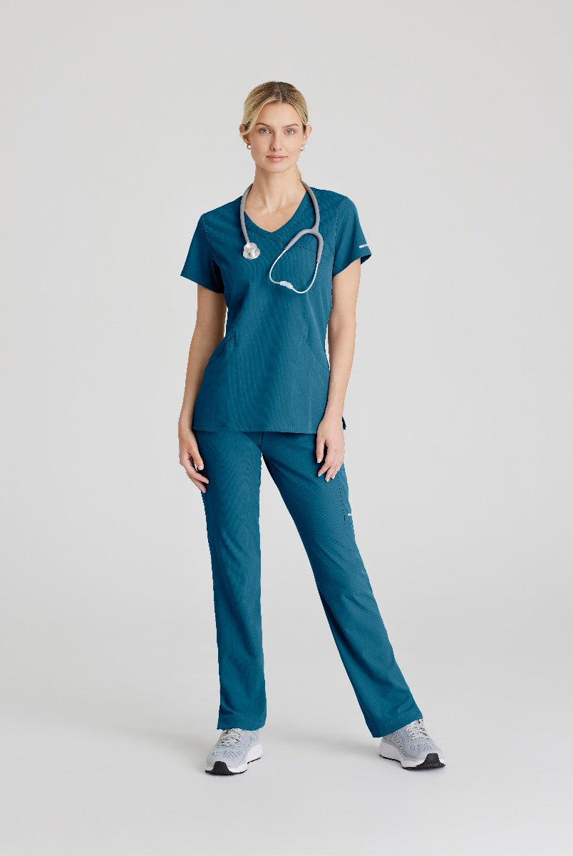 SKECHERS FEMALE RELIANCE 3-POCKET WRAP EFFECT TOP | Bahama / Caribbean